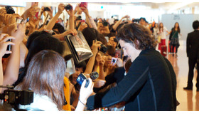 羽田空港でファンサービスを行う、オーランド・ブルーム／主演作『ケープタウン』で緊急来日