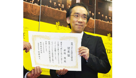 応援大使・就任の証明書を手にした、新垣隆