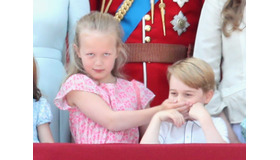 はとこのサヴァンナ・フィリップスに口をふさがれるジョージ王子／エリザベス女王の誕生日パレードにて (C)Getty Images