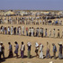 Refugees in the desert. The Sha-alaan One camp, is the worst camp. They have orderly food lines with thousands of refugees waiting calmly for food distribution from the “Charitas” charity organization. Jordan, 1990.
